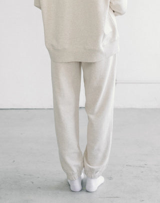 Women wearing an oversized jogger against a neutral photo backdrop. 