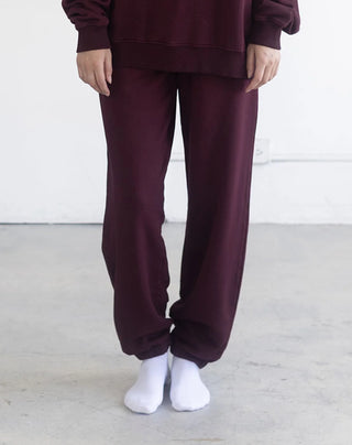 Women wearing an oversized jogger against a neutral photo backdrop. 