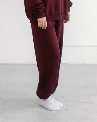 Women wearing an oversized jogger against a neutral photo backdrop. 