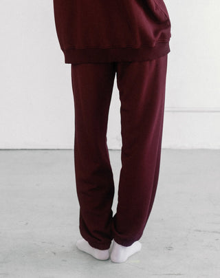 Women wearing an oversized jogger against a neutral photo backdrop. 