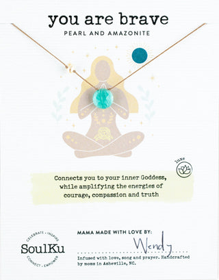 Necklace with pendant featuring a woman in a meditative pose on a white background, with text about its benefits and brand information.