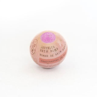 Pink bath bomb with purple top on a white background