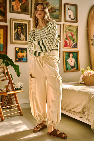 Woman standing in a room with framed artwork on the wall