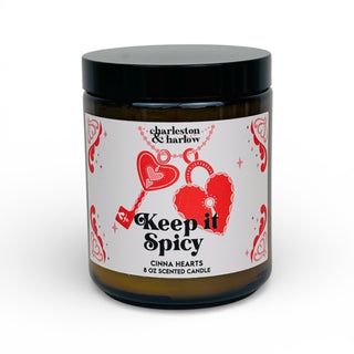 Candle jar with a label featuring hearts and text on a white background