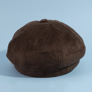 Brown newsboy cap on a light blue background