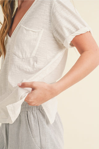 Woman wearing a white blouse with a neutral background