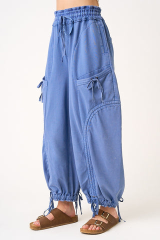 Light blue cargo pants with drawstring waist on a white background
