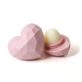 Pink heart-shaped container with a white sphere inside on a white background