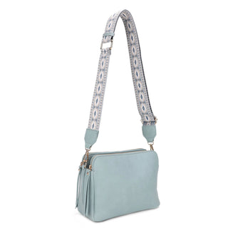 A 3 compartment crossbody bag with a boho guitar strap.