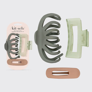 A hair claw clip set shown on a light gray background, including a large olive green claw clip, a pale mint green clip, a rose gold barrette, and the matching retail packaging.