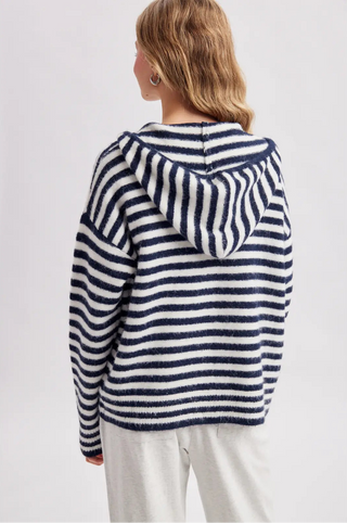 Women wearing a striped hoodie against a neutral background.