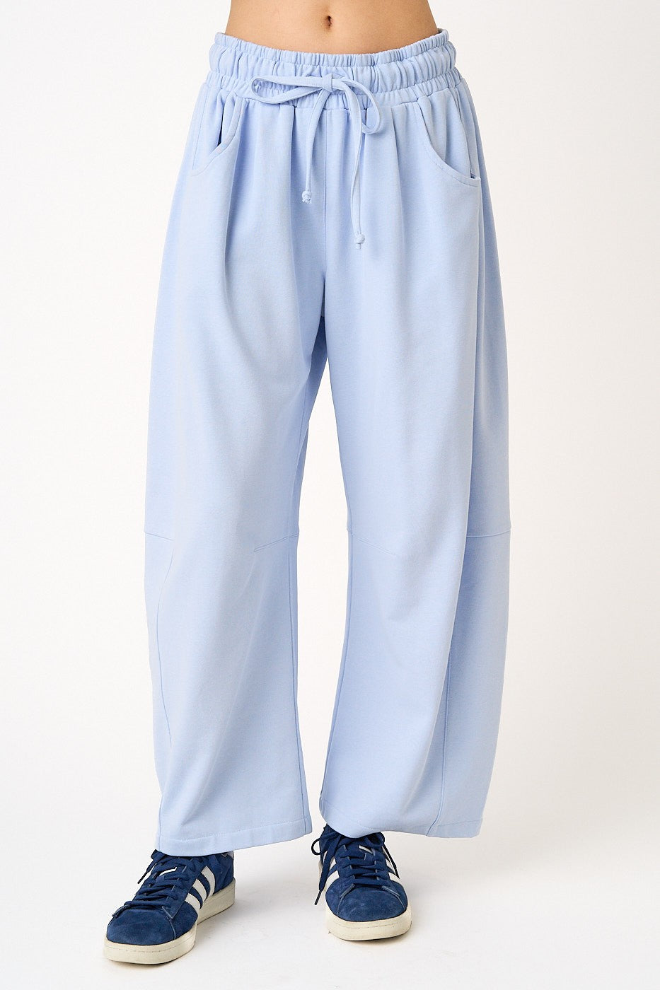 Light blue pants worn by a person on a white background