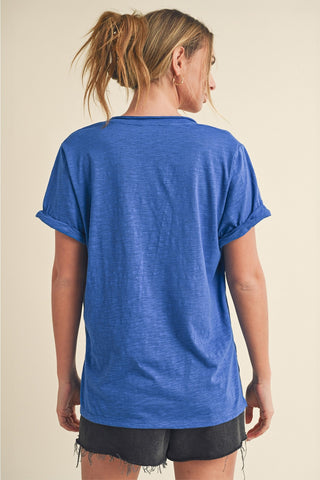 Person wearing a blue t-shirt and black shorts on a beige background