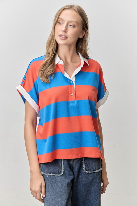 Woman wearing a colorful striped shirt with a plain background