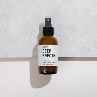 Brown spray bottle labeled 'Deep Breath' on a light gray background