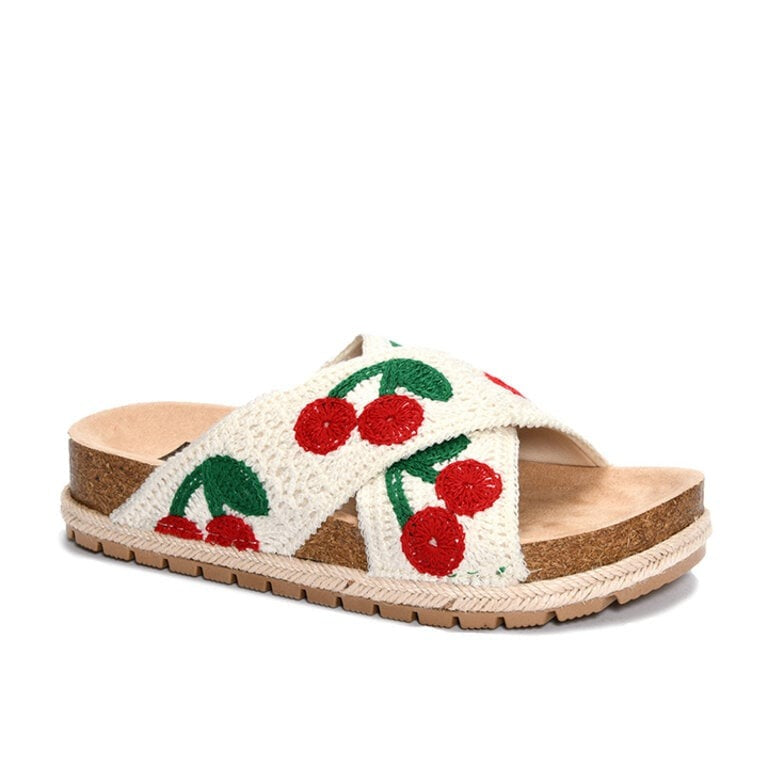 Slide sandal with cherry design on a white background