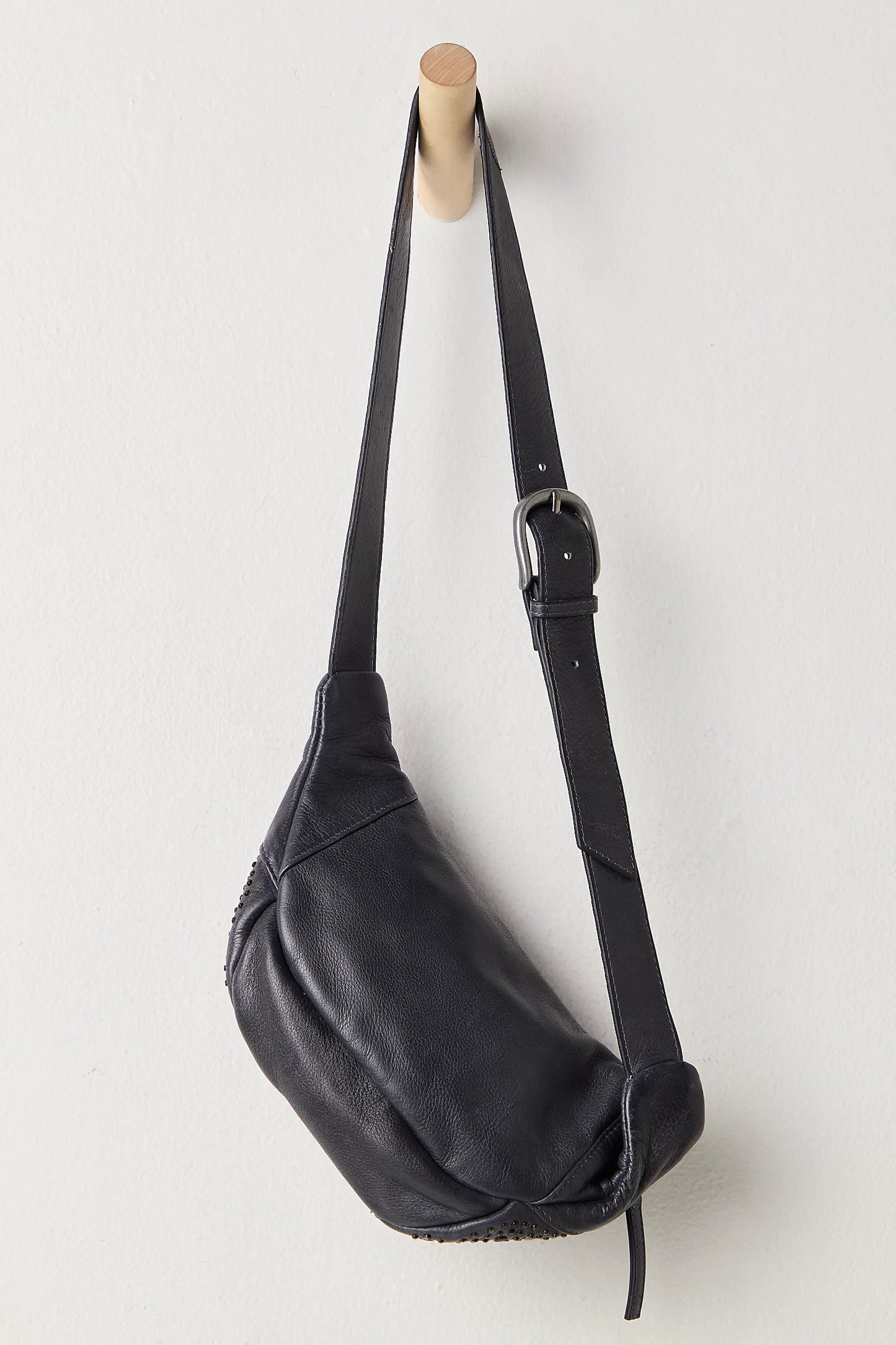 Black leather bag with a strap on a white background