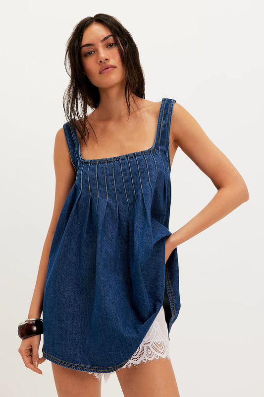 Woman wearing a blue denim dress on a white background