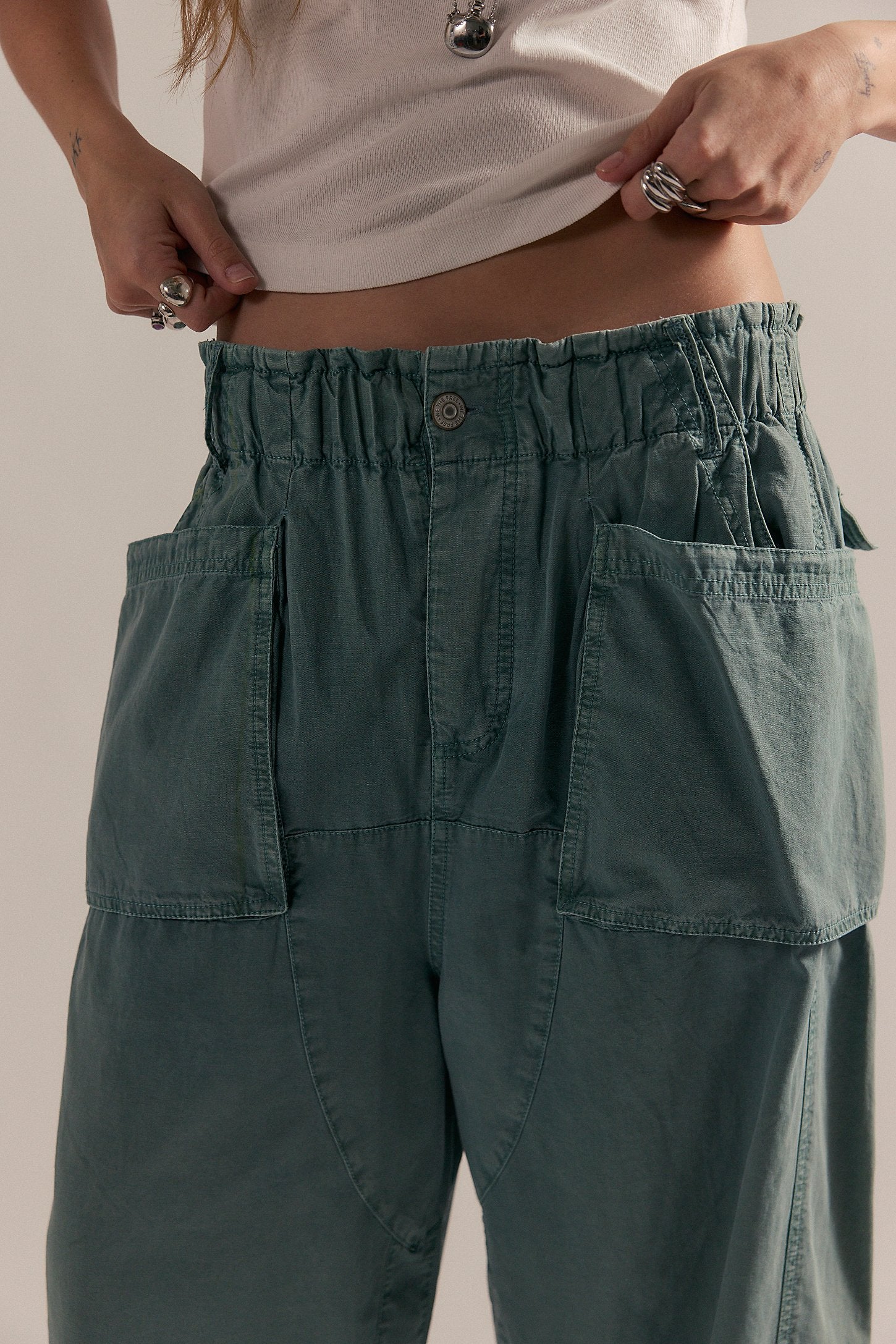 A close up on the waistline of blue cargo harem pants.