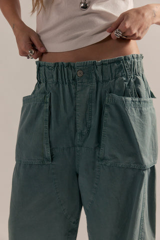 A close up on the waistline of blue cargo harem pants.