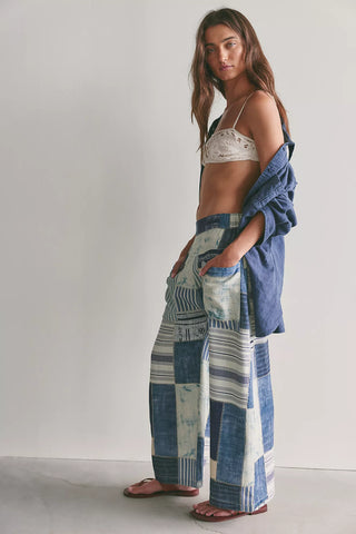 Woman wearing a patchwork dress with a plain background