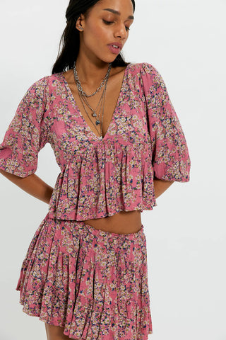 Woman wearing a pink floral dress on a white background