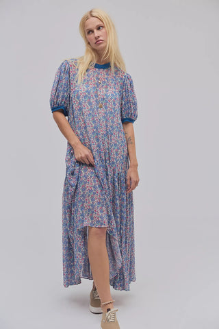 Woman wearing a floral dress on a plain background