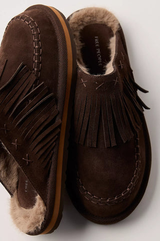 Pair of brown suede shoes with fringes on a light gray background