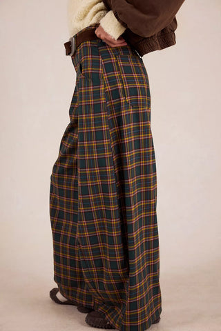Plaid pants worn by a person on a plain background