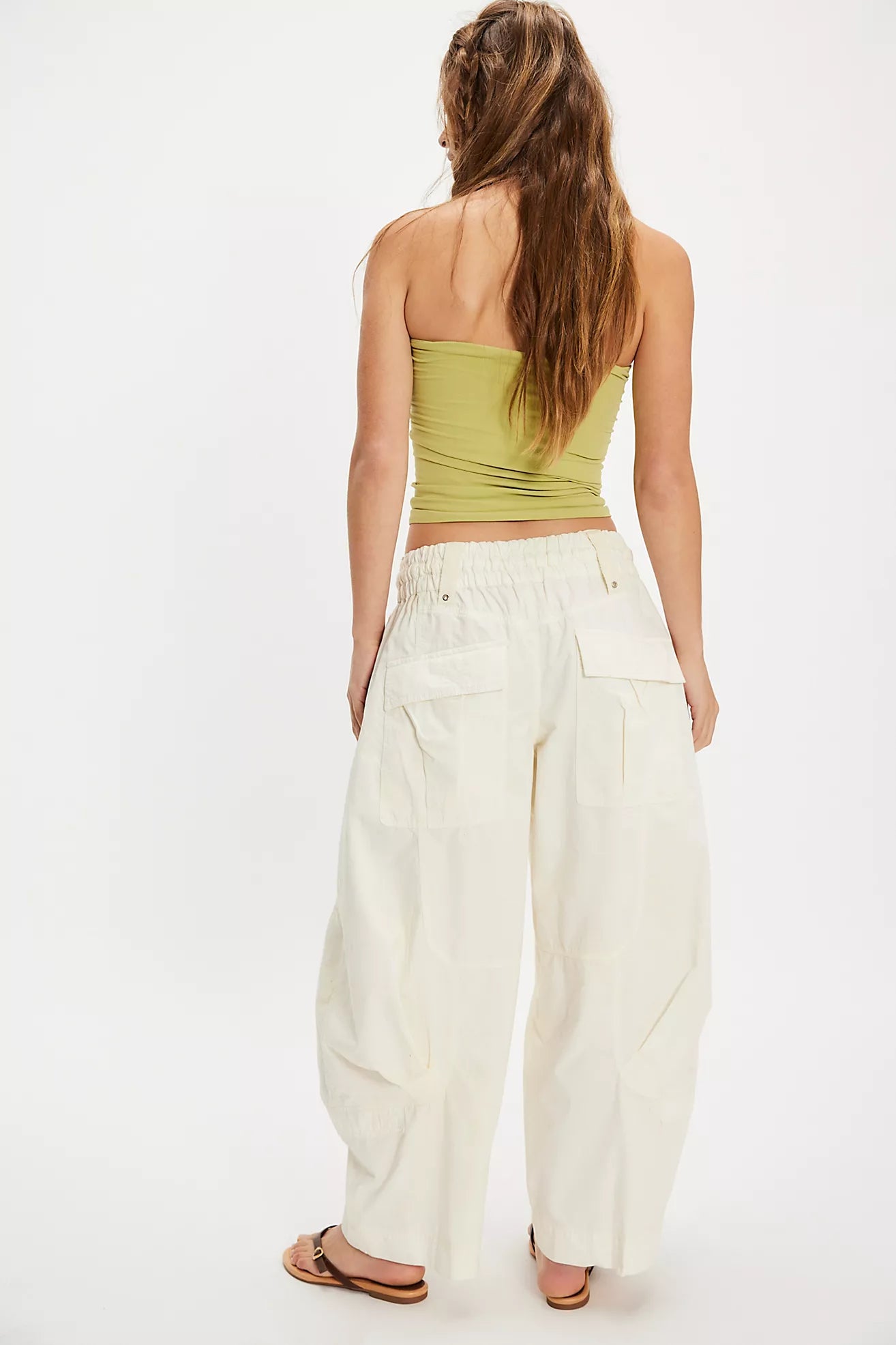 Women wearing white cargo pants and a green top