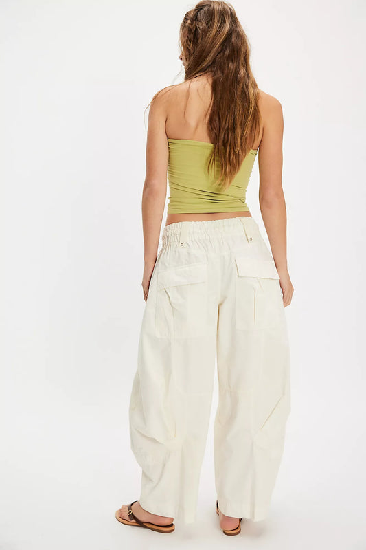 Women wearing white cargo pants and a green top