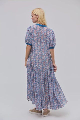Woman wearing a floral dress with a plain background