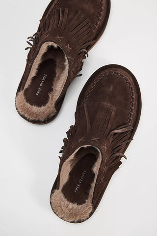 Pair of brown suede moccasin shoes with fringes on a white background