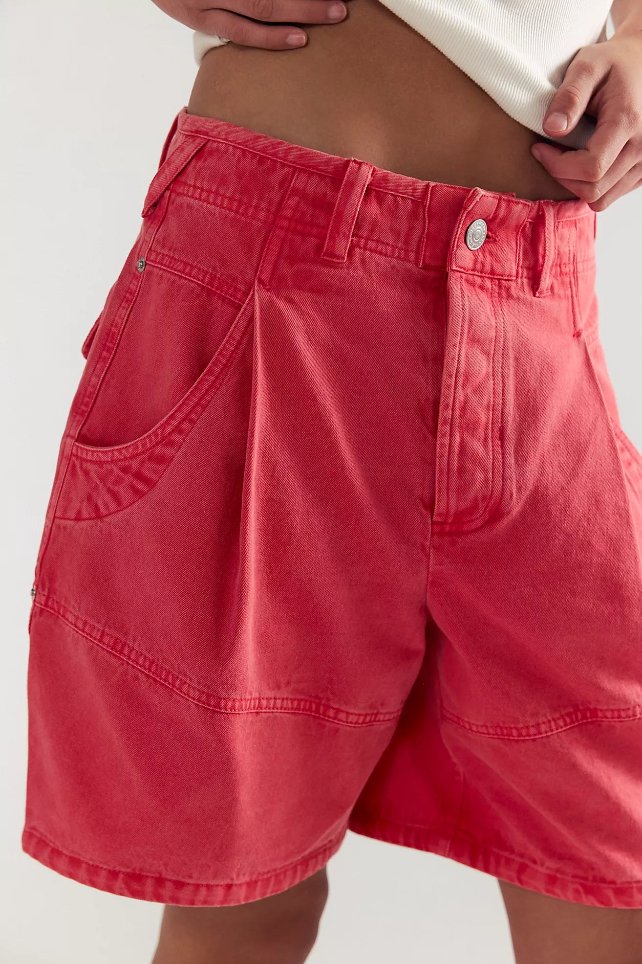Red shorts worn by a person on a white background