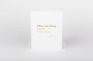 White card with gold text on a white background