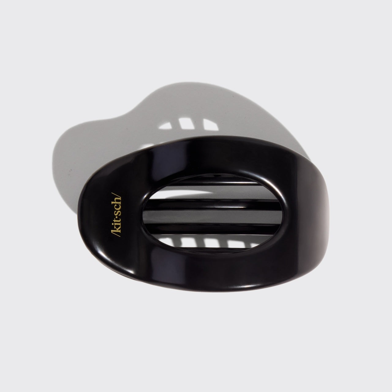 Black and gray hair clip with 'kitsch' branding on a light gray background