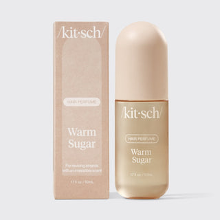 Kit-sch Warm Sugar hair perfume bottle and packaging on a light gray background