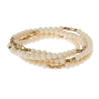 a women's pearl wrap bracelet on a white background
