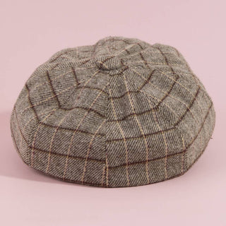 Plaid patterned cap on a pink background