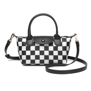 A black and white checkerboard handbag with black leather handles, a black leather flap closure, and a detachable black shoulder strap, shown on a plain white background.