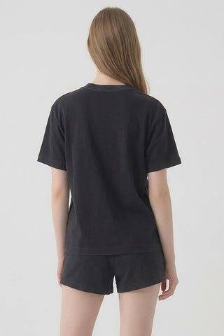 Person wearing a black t-shirt and shorts set on a white background