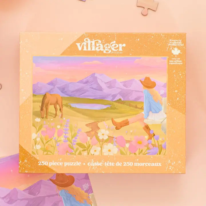 Villager puzzle box with a scenic illustration of a woman, horse, and mountains on a pink background.