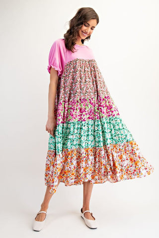 Woman wearing a colorful floral dress on a white background