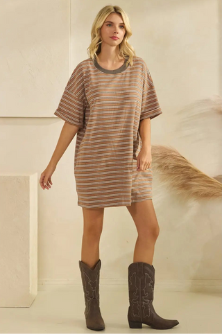 Women wearing a striped t-shirt dress against a neutral background.