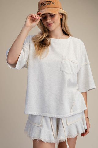 women wearing a grey matching lounge set on a neutral background. 