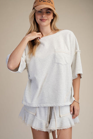 women wearing a grey matching lounge set on a neutral background. 
