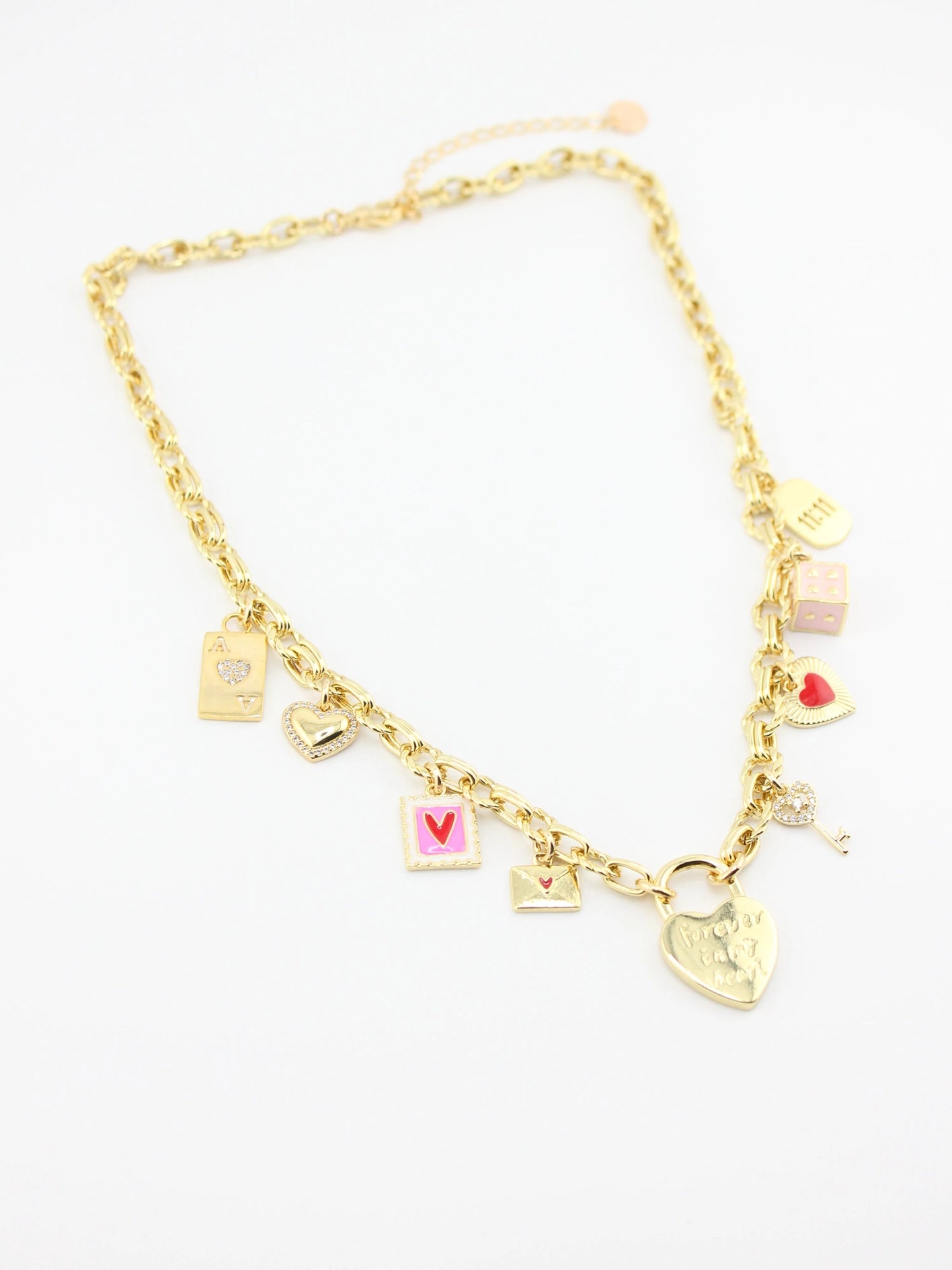 Gold necklace with various charms on a white background