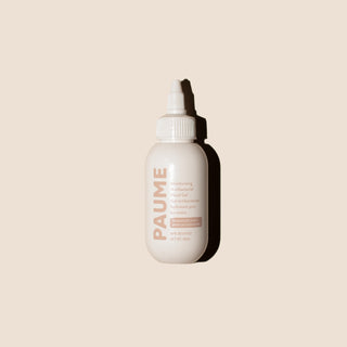 White bottle with 'PAUME' branding on a beige background