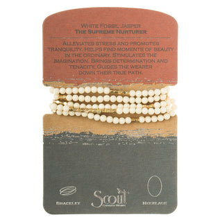 A white semi-precious stone bracelet wrapped around a card, with the brand name 'Scout' visible on the card.