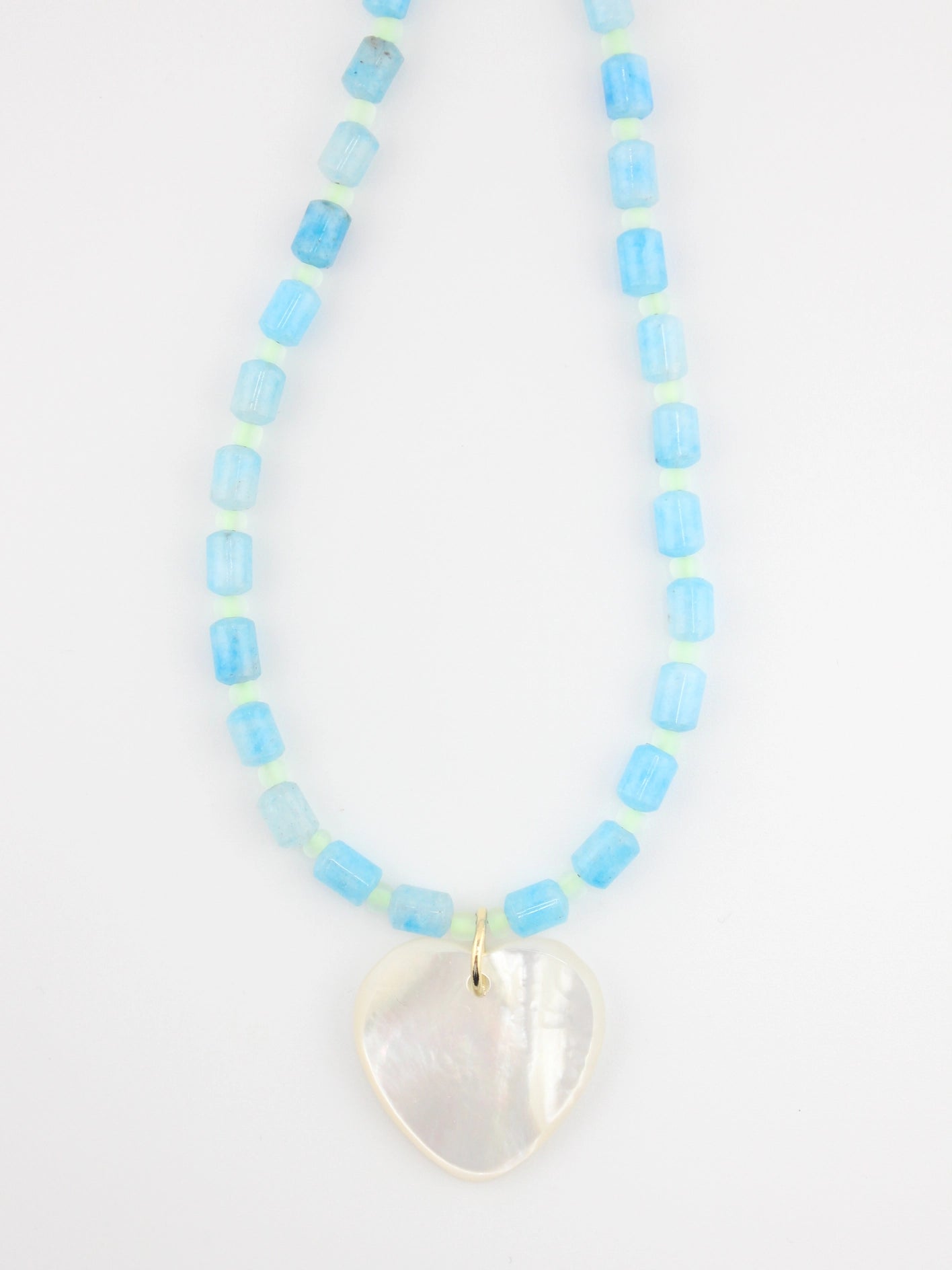 Necklace with light blue beads and a heart-shaped pendant on a white background